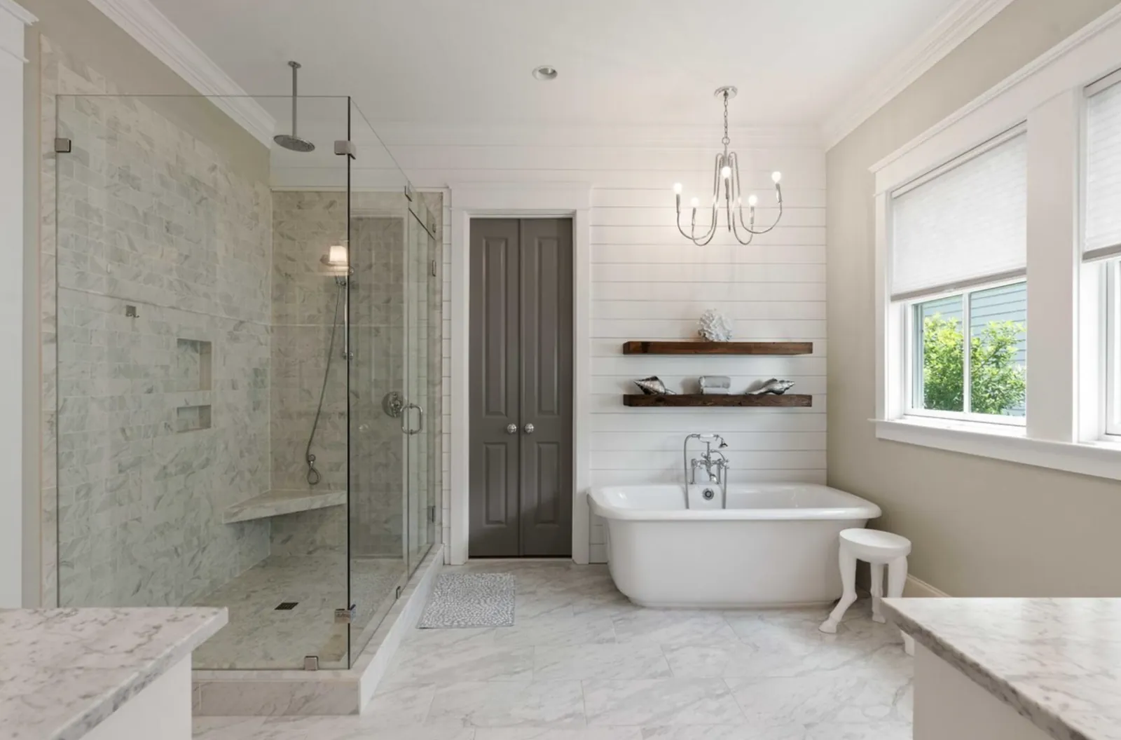 Pike Residence Primary Bathroom: Marble primary bathroom with glass shower and freestanding tub