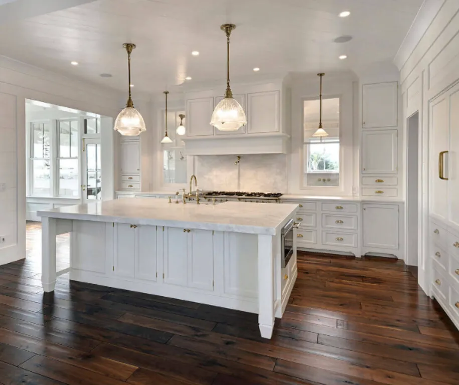 West Ashley Kitchen Remodel: White kitchen remodel with marble island and brass accents